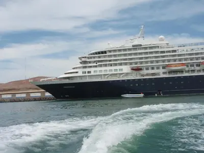 a cruise ship is docked in the water at Paracas Penthouse first line Boardwalk in Paracas