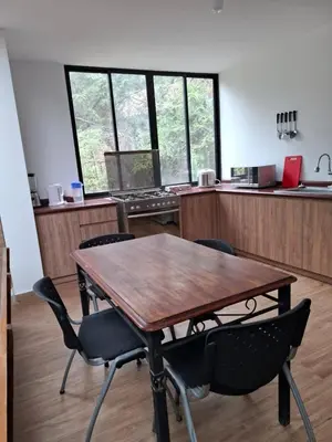 an office with a wooden table and chairs at Cabañas o habitación en Fundo Huabayor in Lima