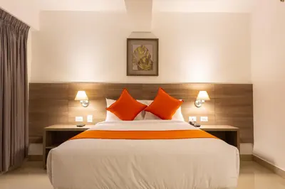 a bedroom with a large bed with orange pillows at Howard Johnson by Wyndham Lima Miraflores Art House in Lima