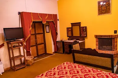 a living room with a tv and a fireplace at Hotel Marqueses in Cusco