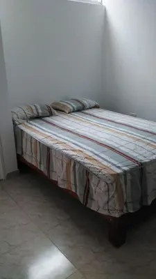 a bed sitting in a corner of a room at Olas inn in Asia