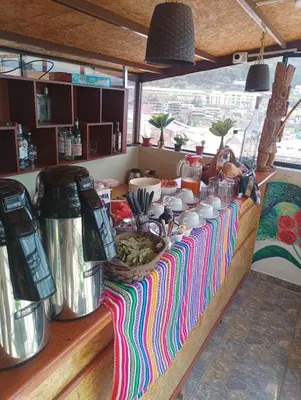 a kitchen counter with a table with food on it at Marvelous Plaza in Cusco