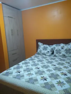 a bedroom with a bed with a quilt on it at PYMABET in Huancavelica