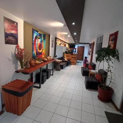 a lobby with couches and a table in a room at CASA SAPANTIANA, cerca a Sacsayhuaman in Cusco