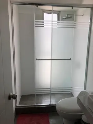 a glass shower in a bathroom with a toilet at Connect in Lima