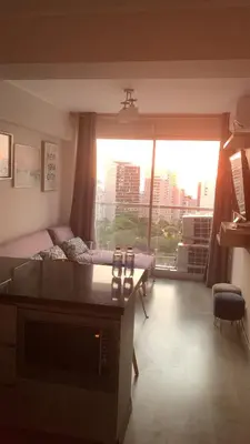 a living room with a couch and a large window at Connect in Lima