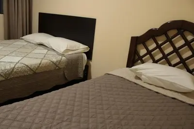 two beds sitting next to each other in a bedroom at Peruvian Wasi - Bed & Breakfast in Lima