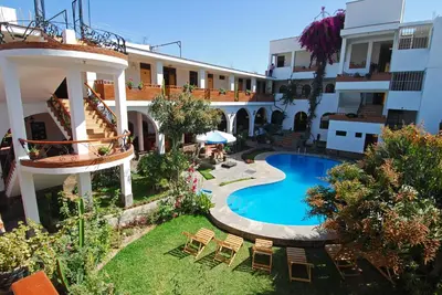 an external view of a hotel with a swimming pool at Hotel Alegria Nasca in Nazca
