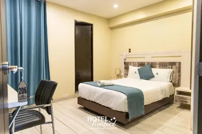 a bedroom with a bed and a desk and a chair at Hotel Konford Cañete in Imperial
