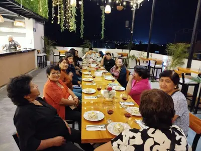 a group of people sitting at a long table at Hotel Konford Cañete in Imperial