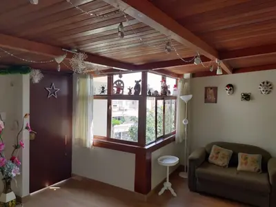 a living room with a couch and a window at CASA BONITA in Lima