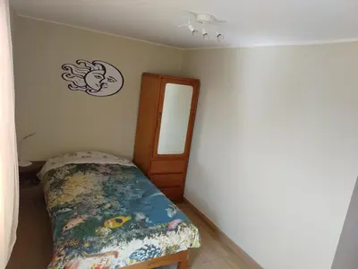 a small bedroom with a bed and a mirror at CASA BONITA in Lima