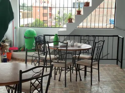 a dining room with a table and chairs at Hostal Boulevard in Nazca