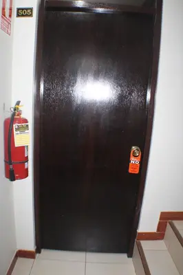 a black door with a sticker on it in a room at ANDINO HOTEL MACHUPICCHu in Machu Picchu