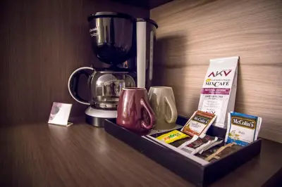 a coffee maker sitting on a counter next to a table at Aku Hotels in Lima
