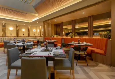 a restaurant with tables and chairs in a room at Sonesta Hotel Miraflores in Lima