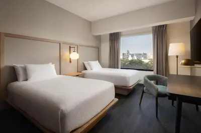 a hotel room with two beds and a desk at Fairfield by Marriott Lima Miraflores in Lima