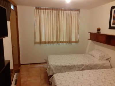 a bedroom with two beds and a window at Inka Ayllu Hospedaje in Lima
