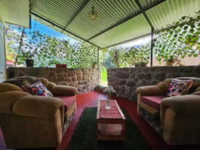 a living room with two couches and a table at Valle verde, Hostel & camping in Urubamba