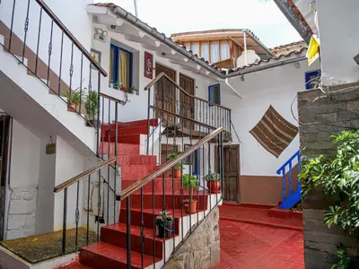 a staircase in a house with red steps at LO NUESTRO House in Cusco