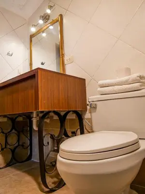 a bathroom with a toilet and a sink and a mirror at LO NUESTRO House in Cusco