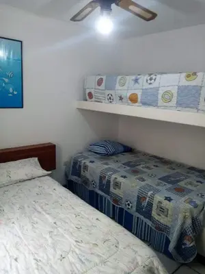 a bedroom with two beds and a ceiling fan at El Refugio in Punta Hermosa