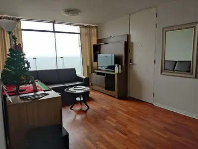 a living room with a couch and a table at Arena Costa Lima private rooms Peru in Lima