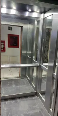 an empty room with a metal wall and a mirror at Arena Costa Lima private rooms Peru in Lima