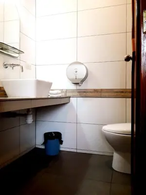 a bathroom with a sink and a toilet at Hotel Dia y Noche in Lima