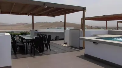 a patio with a table and chairs and a swimming pool at Donde Lalo in Asia