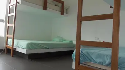 a bedroom with two bunk beds in a room at Donde Lalo in Asia