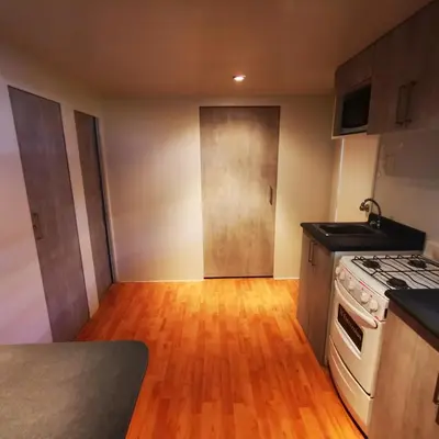 a kitchen with a stove and a counter top at Casa Caravanas in Paracas
