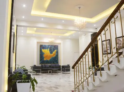 a lobby with couches and a painting on the wall at Real Hotel in Huánuco