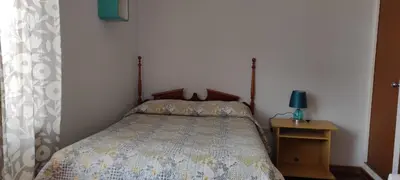 a bedroom with a bed and a table with a lamp at EL ENSUEÑO in Lima