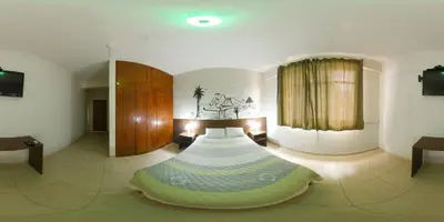 a bedroom with a bed in the middle of a room at Waldorf in Lima