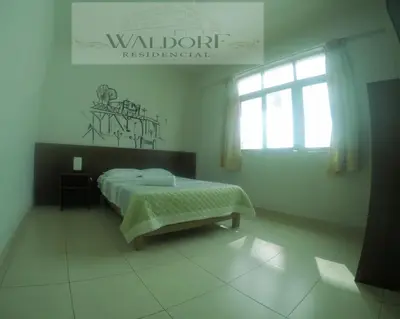 a white bedroom with a bed and a window at Waldorf in Lima