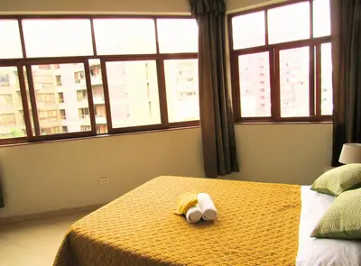 a bedroom with a bed with a stuffed animal on it at Residencial Waldorf in Lima