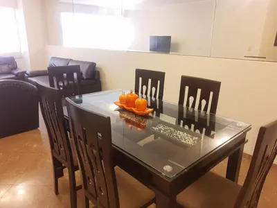 a dining room table and chairs with oranges on it at suite pardo CAA Miraflores in Lima