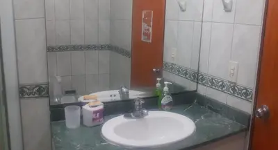 a bathroom with a sink and a mirror at suite pardo CAA Miraflores in Lima