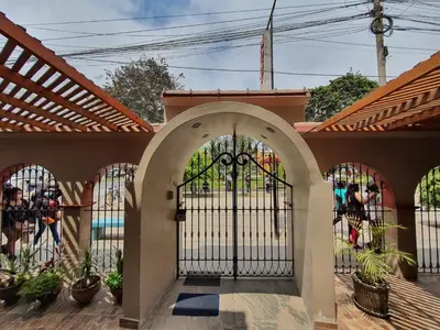 an entrance to a house with an iron gate at Hotel Colibri in San Vicente de Cañete