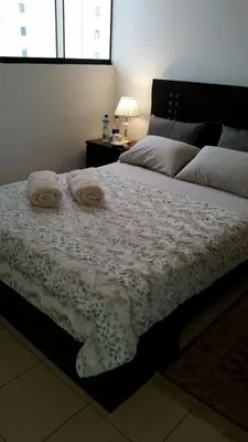 a bedroom with a bed with two towels on it at Habitación RRB in Lima