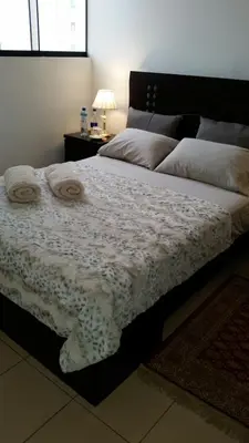 a bedroom with a large bed with towels on it at Habitación RRB in Lima