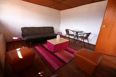 a living room with a couch and a table at CASONA TORDO - A 3 Cdras de la Plaza - Habitaciones con baño privado in Cusco