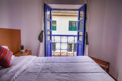 a bedroom with a bed and an open window at CASONA TORDO - A 3 Cdras de la Plaza - Habitaciones con baño privado in Cusco