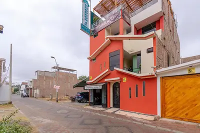 a red building on the side of a street at Hospedaje Muñoz in Ica