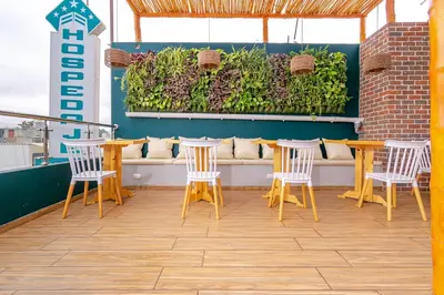 a patio with chairs and a table and a bench at Hospedaje Muñoz in Ica