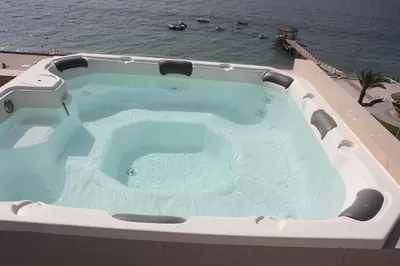 a large hot tub on top of a building next to the ocean at Paracas top tower beach front in Paracas