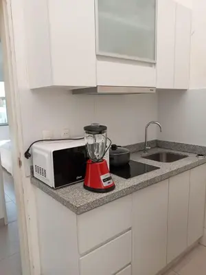 a blender sitting on a kitchen counter next to a sink at Paracas top tower beach front in Paracas