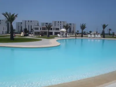 a large swimming pool in front of a building at Paracas top tower beach front in Paracas