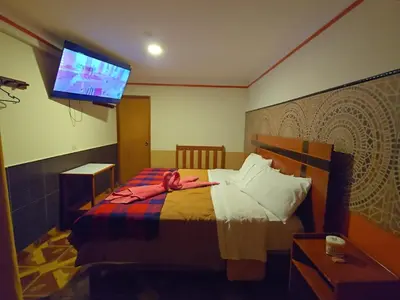 a woman laying on a bed in a room at Hotel Manantial in Churín